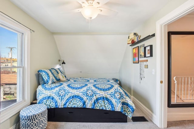 bedroom featuring vaulted ceiling, visible vents, a ceiling fan, carpet floors, and baseboards