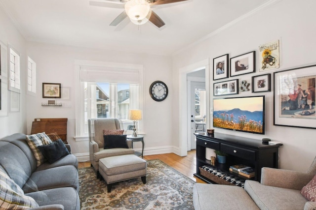 living room featuring plenty of natural light, baseboards, wood finished floors, and ceiling fan