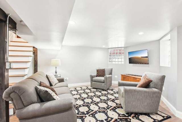 living area featuring stairway, baseboards, wood finished floors, and recessed lighting