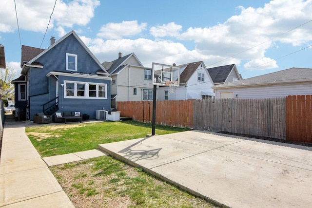 exterior space featuring a residential view, fence private yard, a patio, an outdoor living space, and a lawn