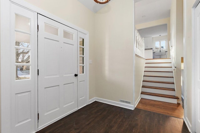 entrance foyer featuring dark wood-type flooring and a wealth of natural light