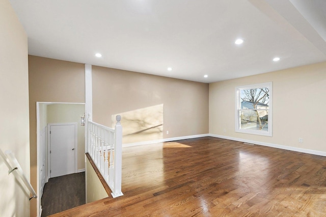 empty room with dark hardwood / wood-style flooring