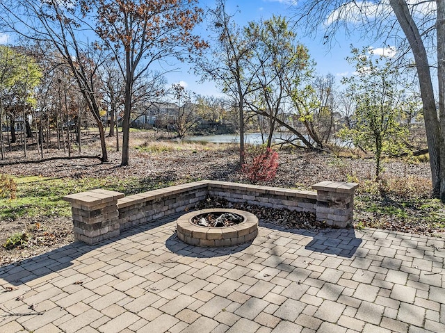 view of patio / terrace featuring an outdoor fire pit