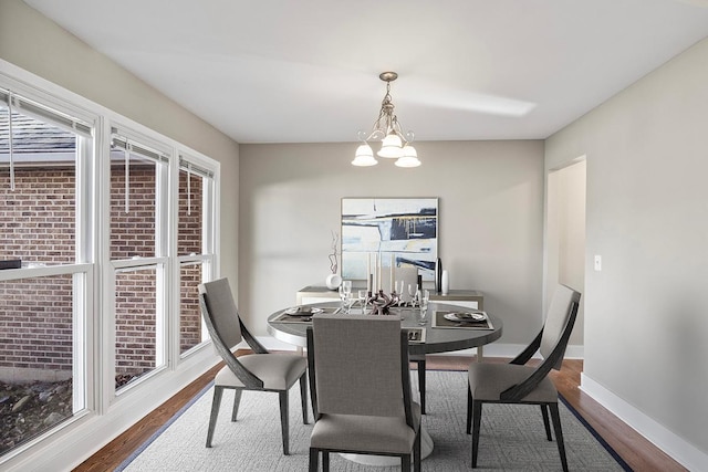 dining room featuring wood-type flooring and a notable chandelier