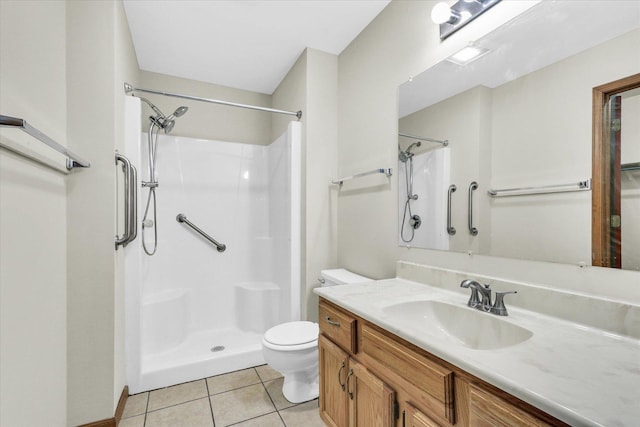 bathroom featuring toilet, tile patterned floors, walk in shower, and vanity