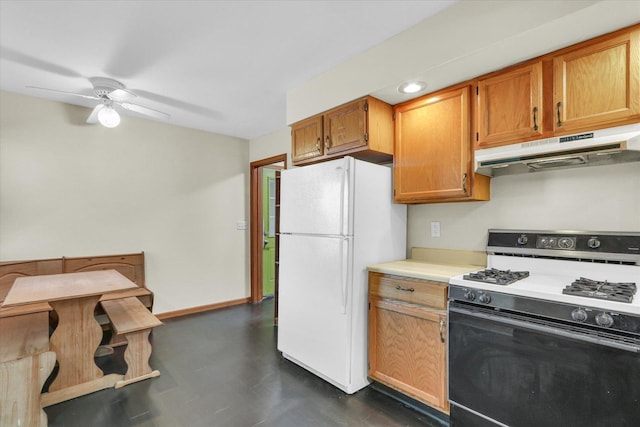 kitchen featuring white refrigerator, ceiling fan, and gas stove