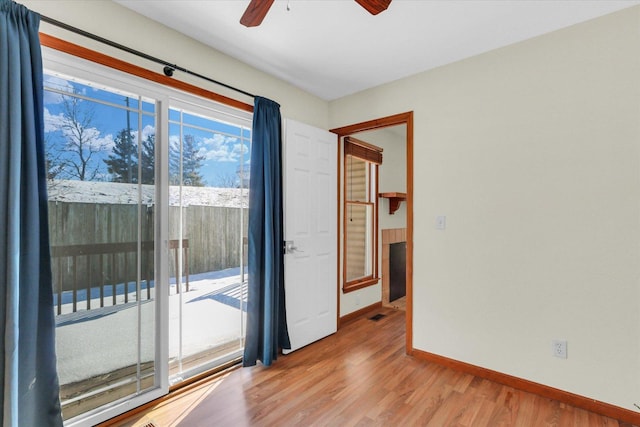 empty room featuring light wood-type flooring and ceiling fan