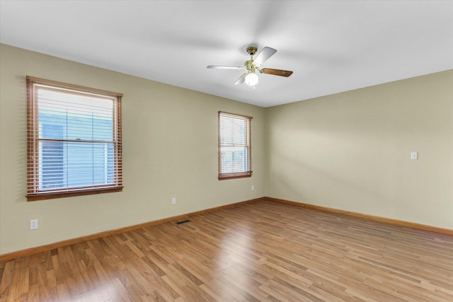 empty room with light wood-type flooring and ceiling fan