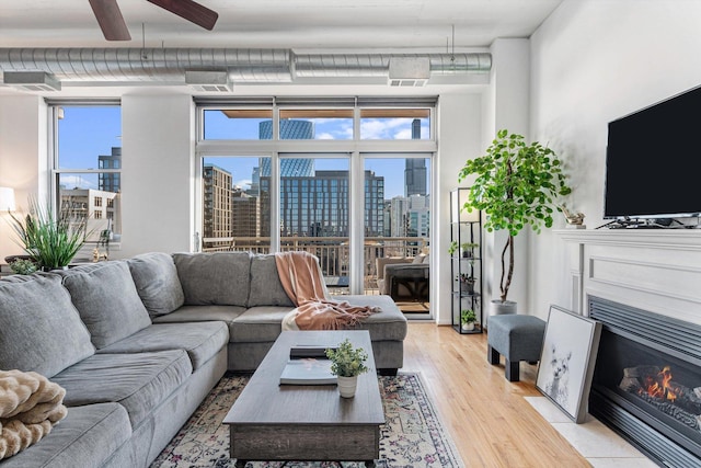 living room featuring light hardwood / wood-style floors and ceiling fan