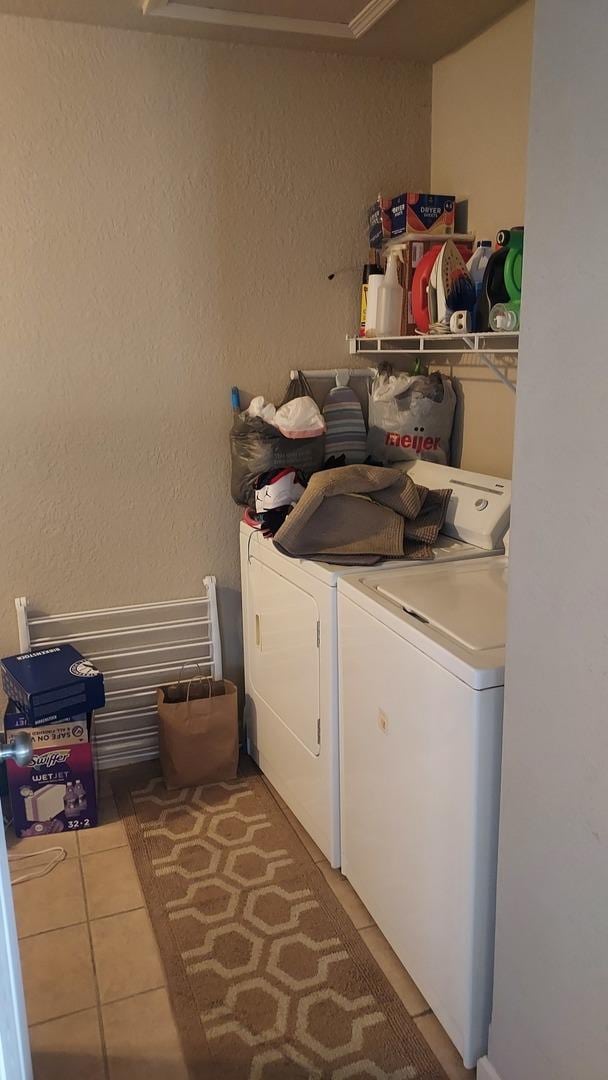 laundry area with tile patterned flooring and independent washer and dryer