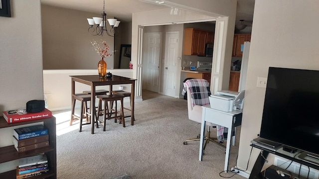 dining space with a chandelier and light colored carpet