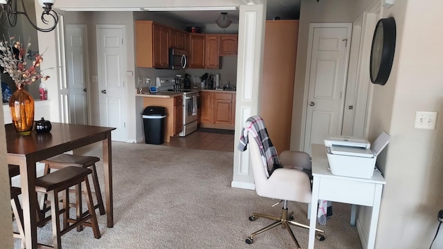 kitchen with carpet flooring and stainless steel appliances