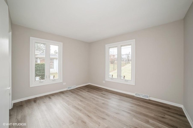 spare room with hardwood / wood-style floors