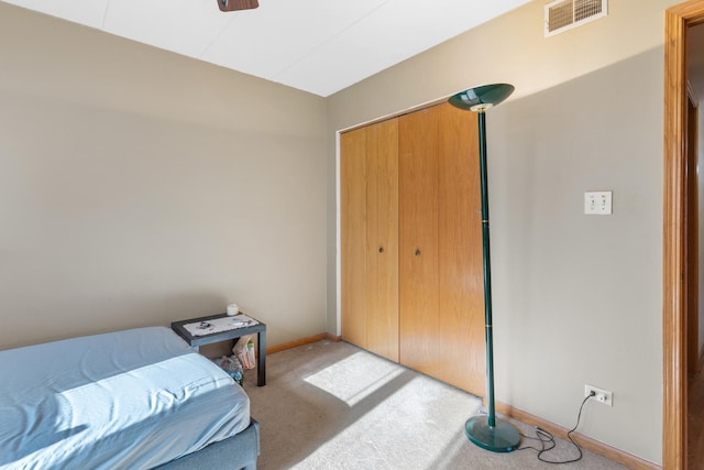 bedroom with light colored carpet and a closet