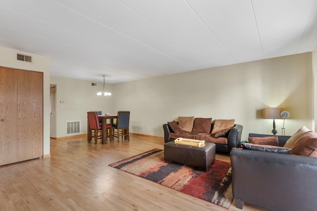 living room with hardwood / wood-style floors and a chandelier