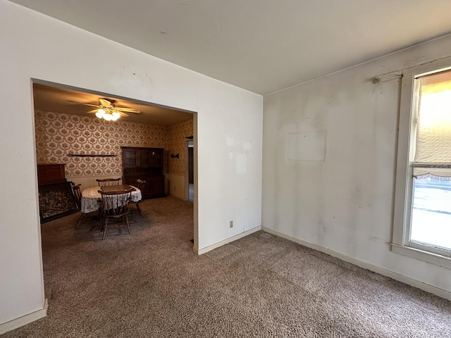 carpeted spare room with ceiling fan