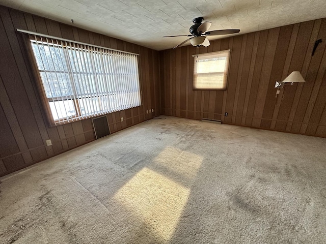 carpeted spare room with ceiling fan