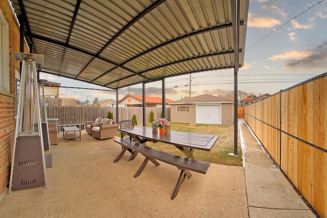 patio terrace at dusk with an outbuilding and an outdoor hangout area