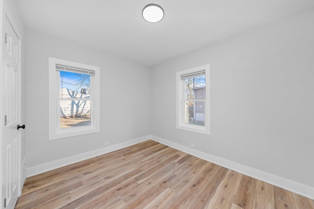 empty room featuring plenty of natural light and light wood-type flooring