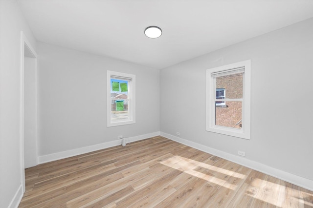 empty room with light hardwood / wood-style flooring