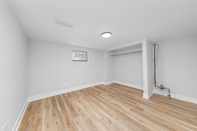 unfurnished bedroom with a closet and light wood-type flooring