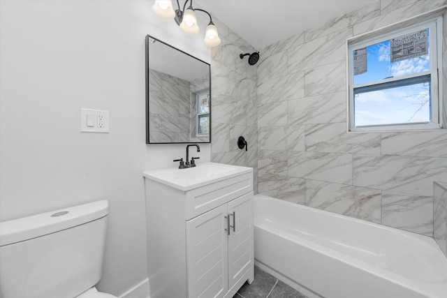 full bathroom with tile patterned floors, toilet, vanity, and tiled shower / bath