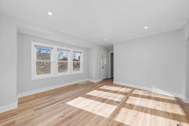 empty room with light hardwood / wood-style flooring