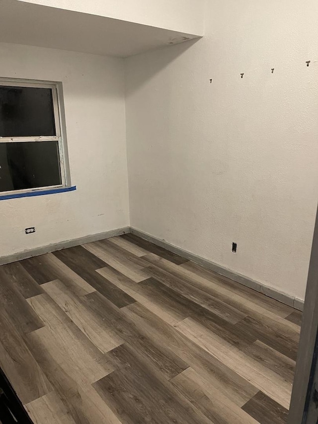 spare room with dark hardwood / wood-style flooring