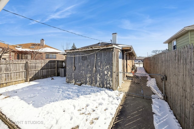 yard covered in snow featuring fence