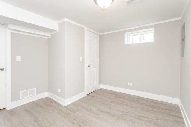 unfurnished room featuring light wood-type flooring and crown molding