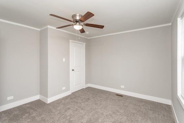 empty room featuring carpet, ceiling fan, and crown molding