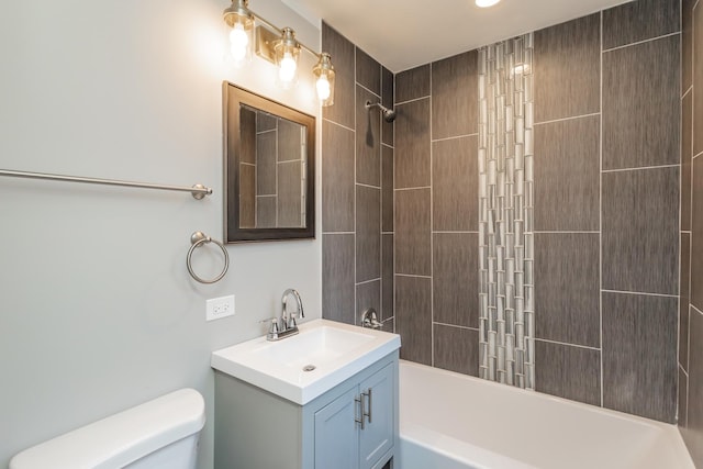 full bathroom with vanity, toilet, and tiled shower / bath