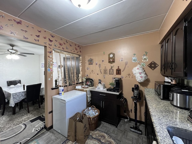 laundry room featuring ceiling fan and sink