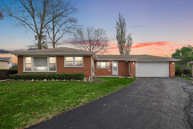 single story home with a lawn and a garage