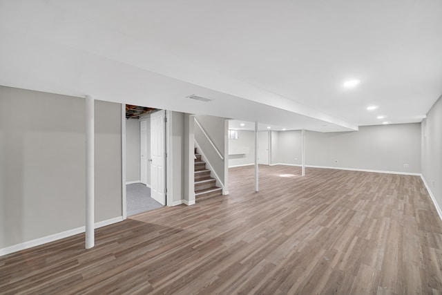 basement featuring hardwood / wood-style floors