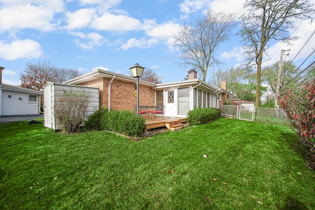 back of house with a lawn and a wooden deck