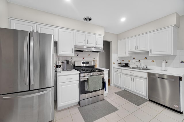 kitchen with light tile patterned flooring, sink, white cabinetry, and stainless steel appliances