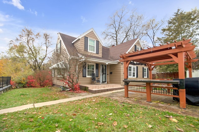 view of front of property with a front yard and a pergola