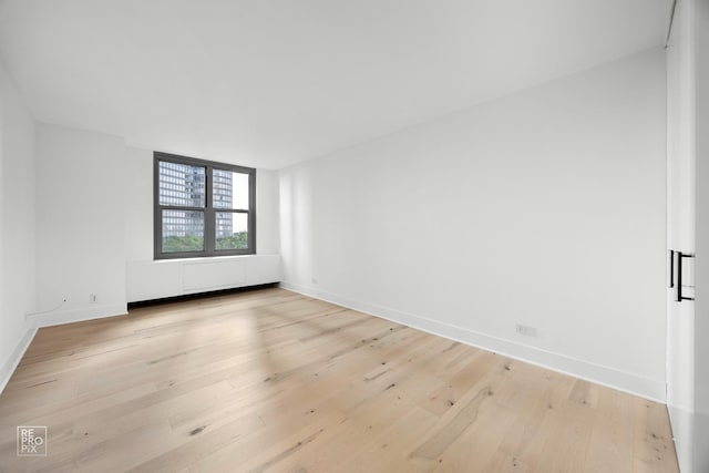 spare room featuring light hardwood / wood-style flooring