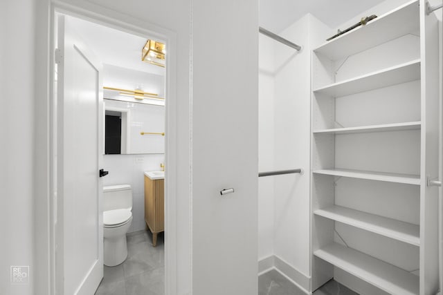 bathroom featuring vanity, tile walls, and toilet