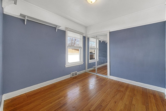 unfurnished room with hardwood / wood-style floors