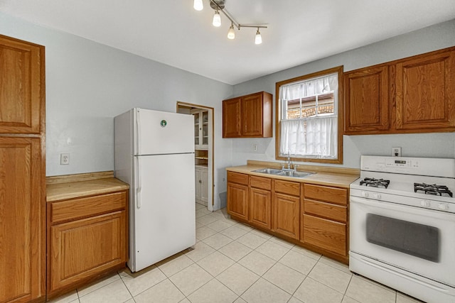 kitchen featuring white appliances and sink