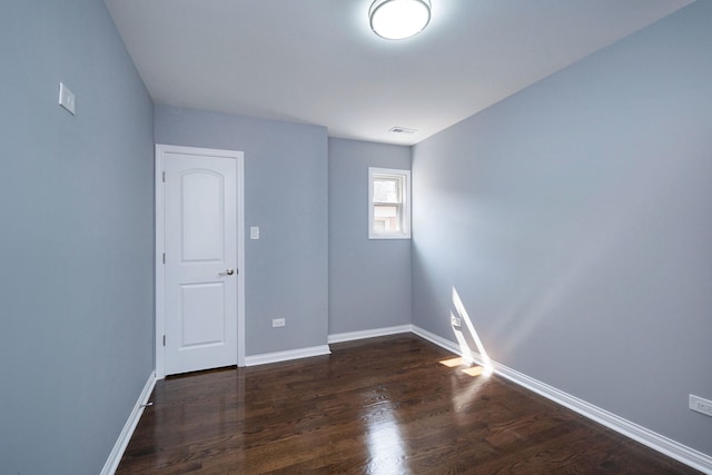 empty room featuring dark hardwood / wood-style flooring