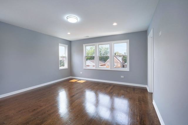 spare room featuring dark wood-type flooring