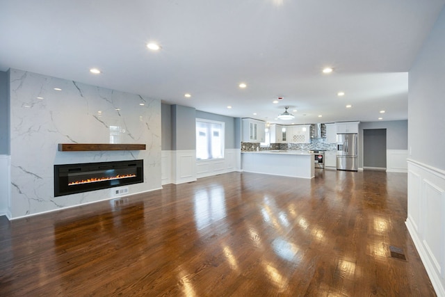 unfurnished living room featuring dark hardwood / wood-style floors and a fireplace