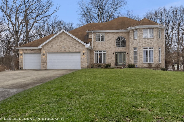 view of front of property with a front yard and a garage