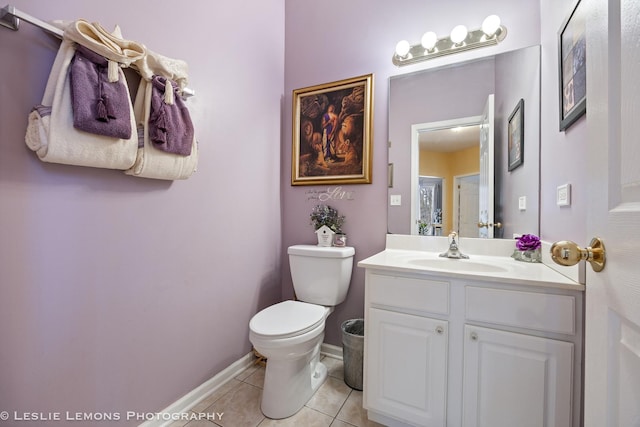 bathroom with tile patterned flooring, vanity, and toilet