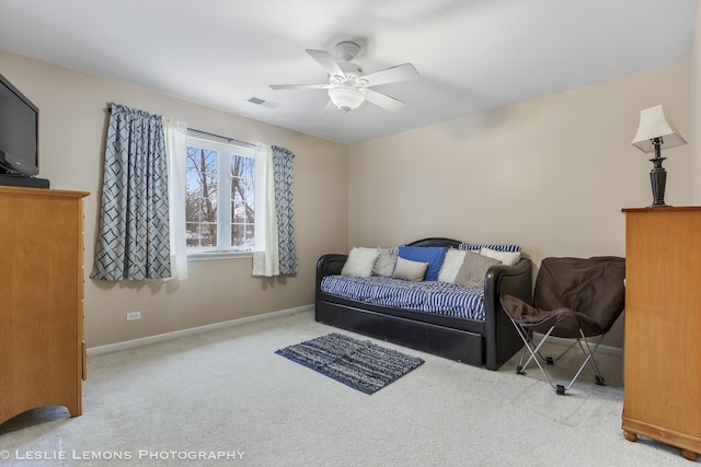 carpeted living room featuring ceiling fan