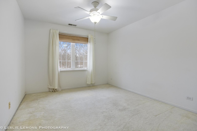 unfurnished room with ceiling fan and light colored carpet