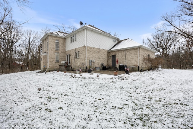 view of snow covered rear of property